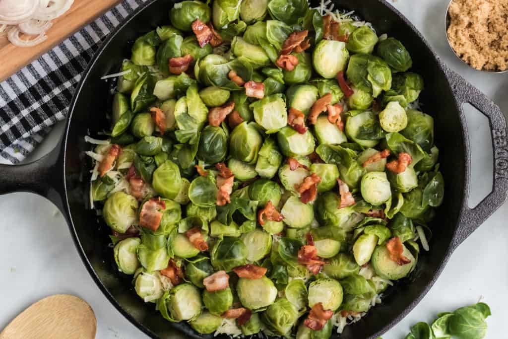 layering the brussels sprouts au gratin in cast iron pan