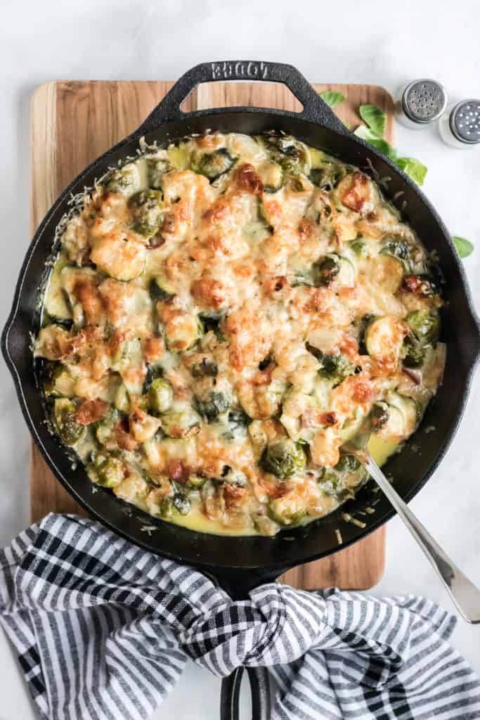 brussels sprouts au gratin in a cast iron pan