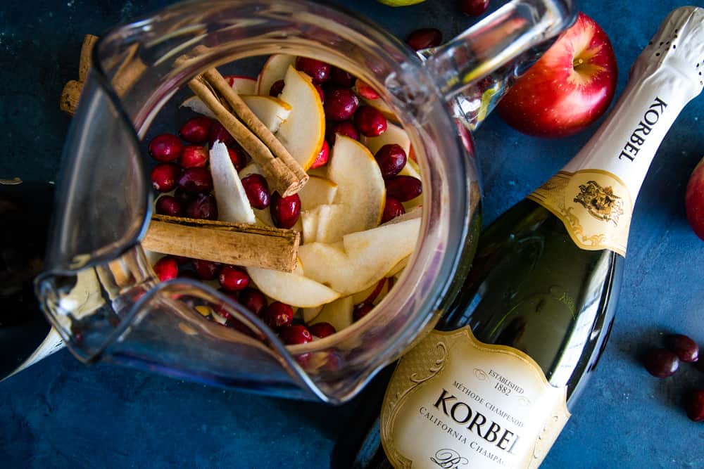 pitcher of fruit and bottle of korbel