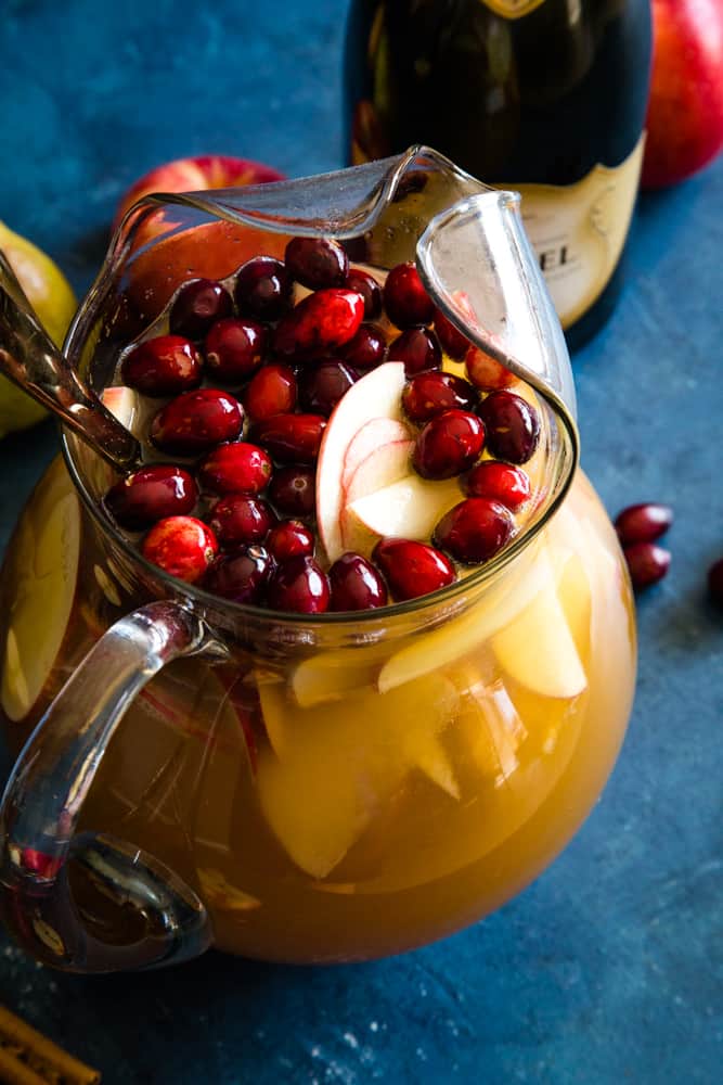 pitcher of christmas champagne punch with cranberries