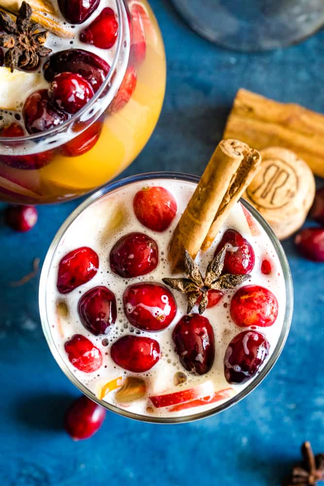 glass of christmas champagne punch with cranberries