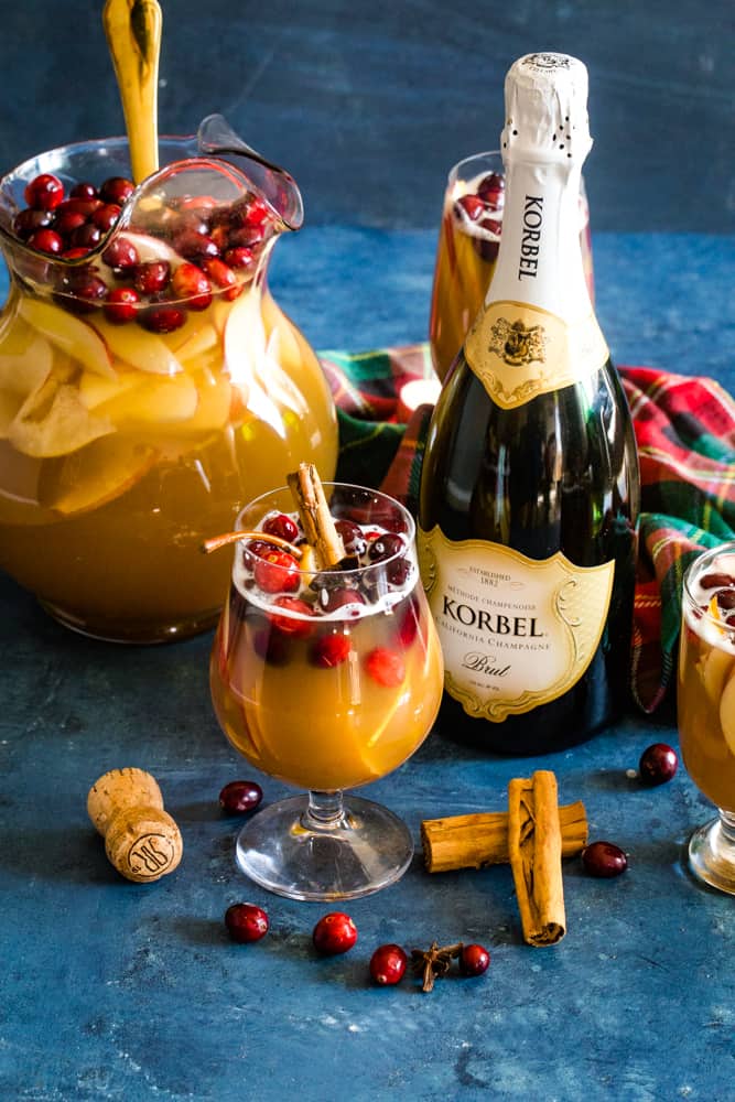 glass and pitcher of christmas champagne punch