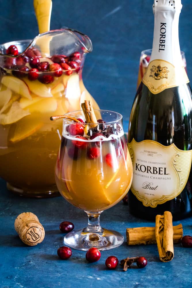 glass and pitcher of christmas champagne punch