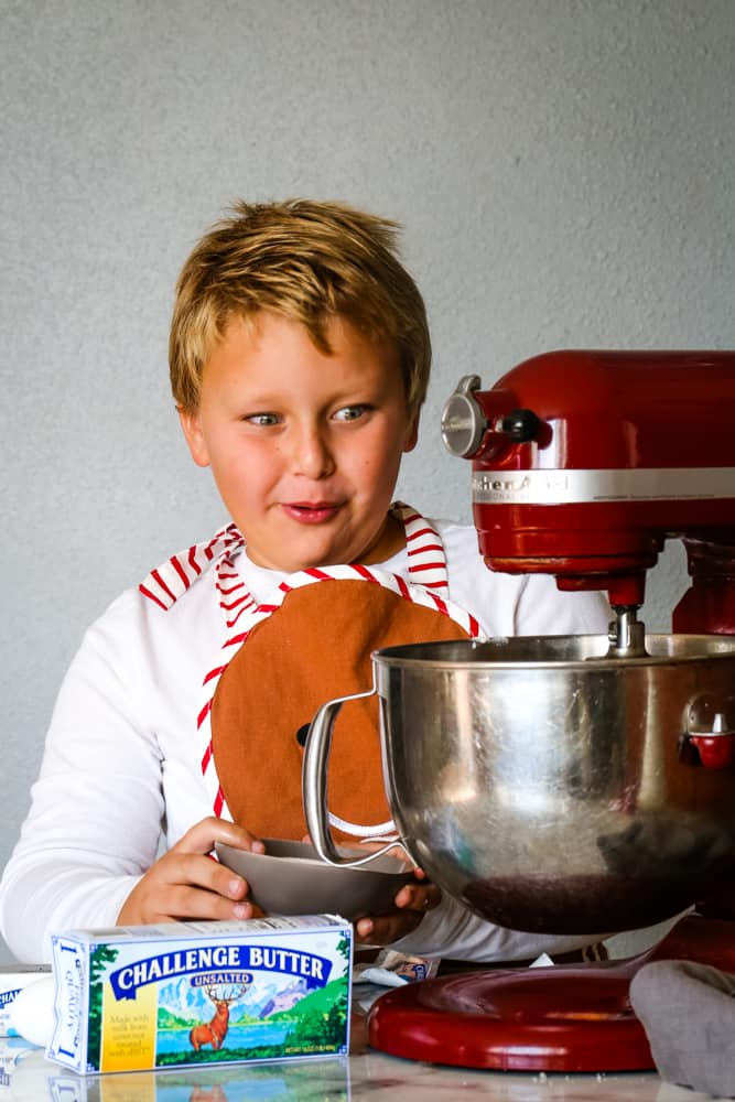 boy with mixer making cranberry spice cake