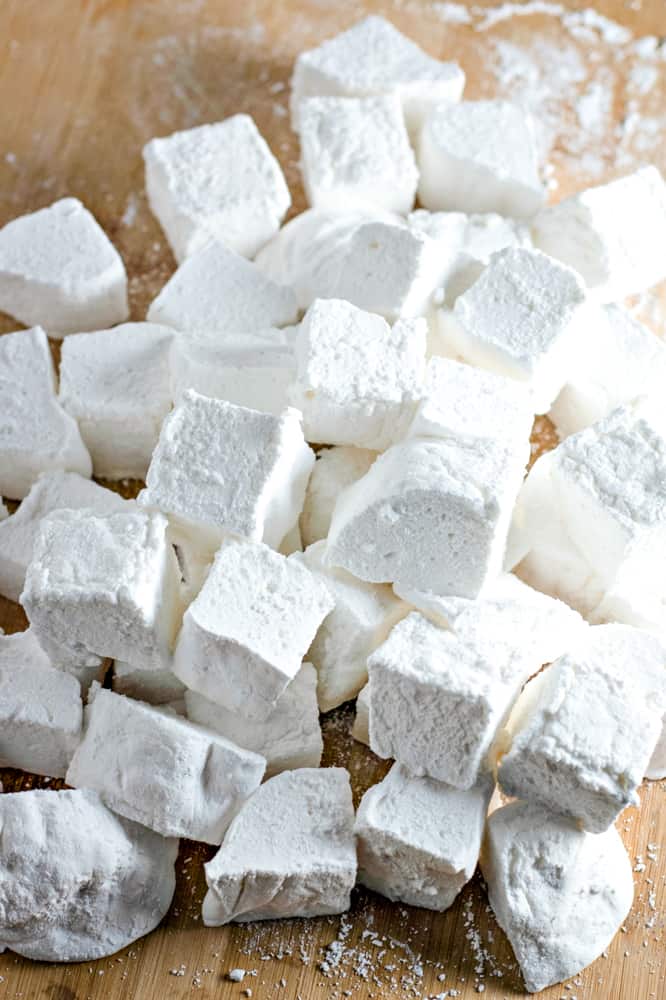 cutting board with a bunch of cut vanilla marshmallows