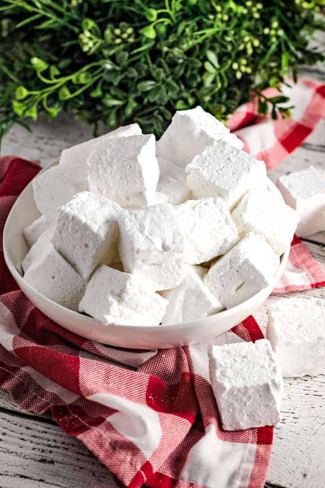 homemade vanilla marshmallows in white bowl with red dish towel