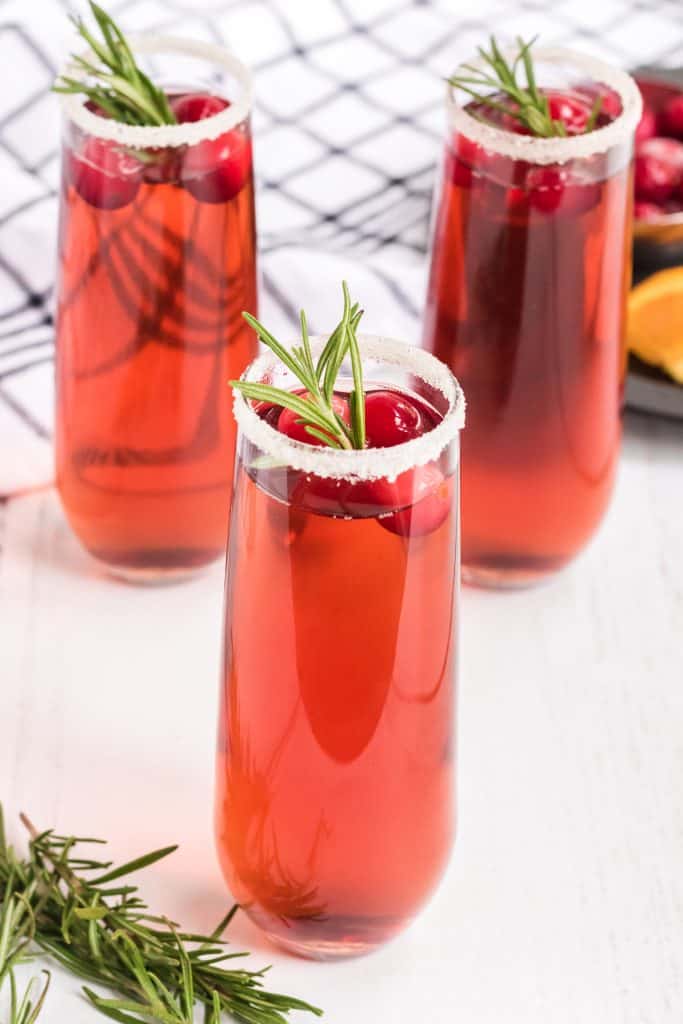 three glasses of cranberry mimosas