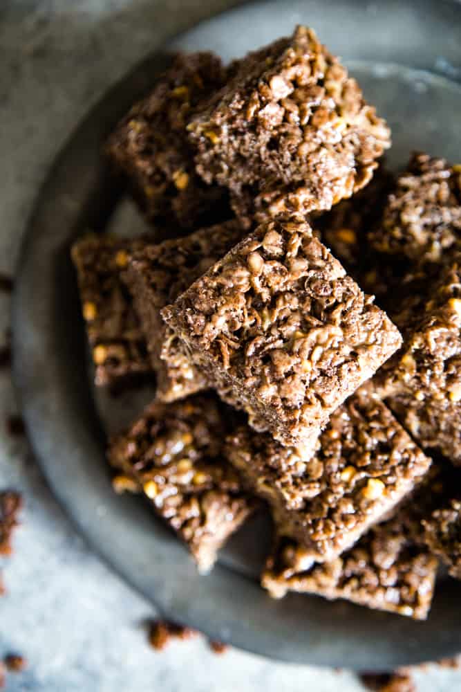 Overhead shot of stacked chocolate peanut butter squares on a metal plate. 