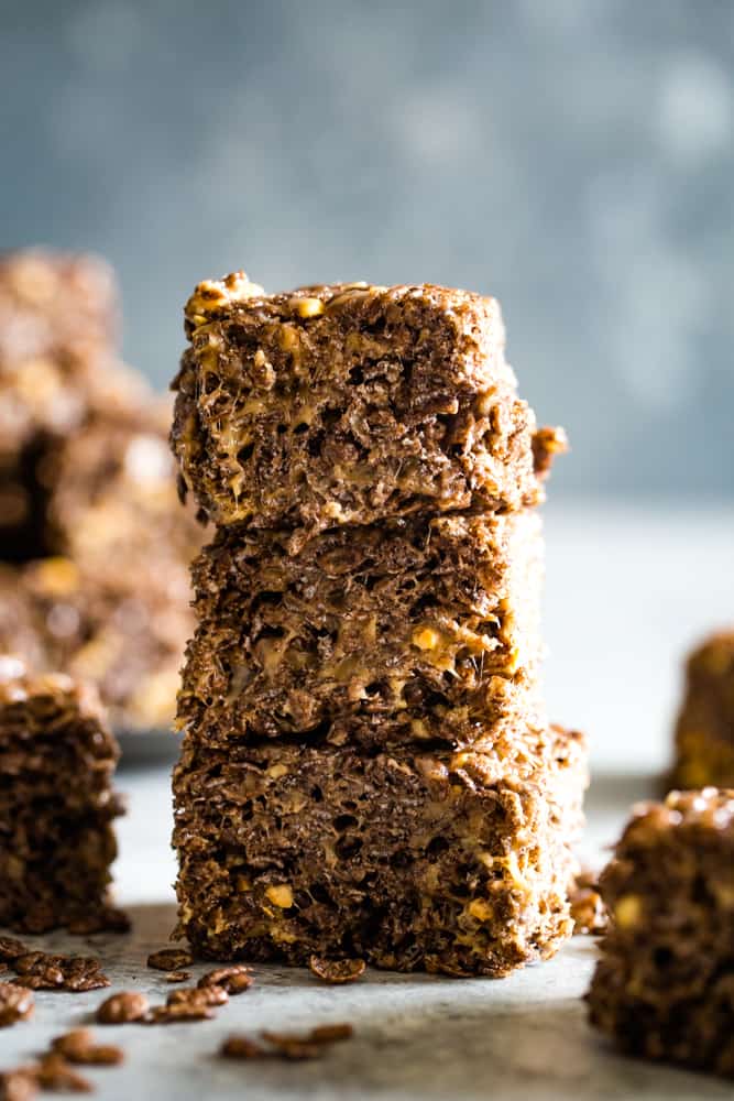 Three stacked thick chocolate peanut butter marshmallow squares. 