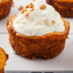 mini pumpkin cheesecakes on white wood board