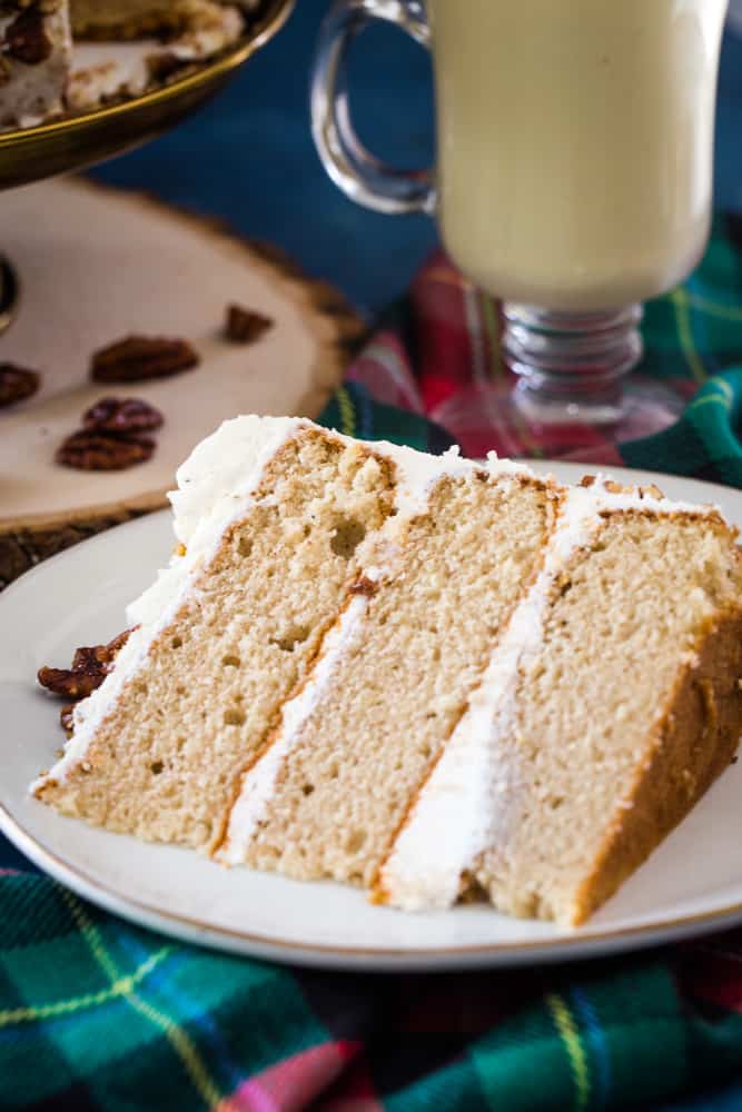 slice of eggnog layer cake on white cake