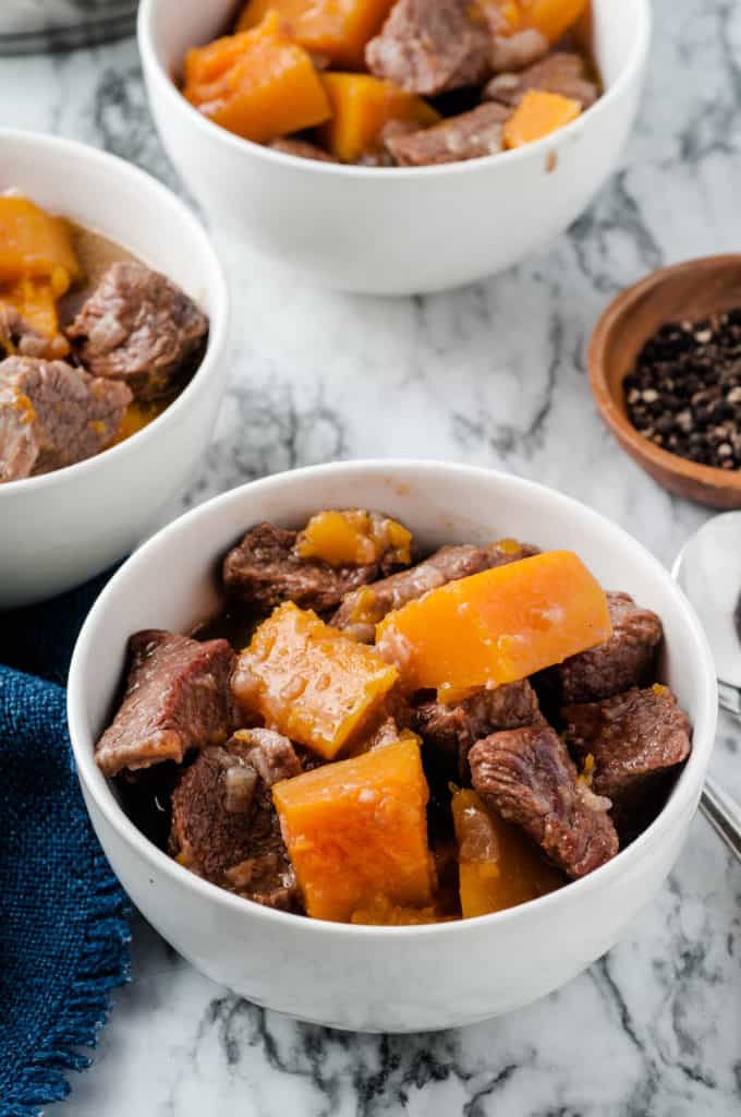 butternut squash beef stew in white bowls