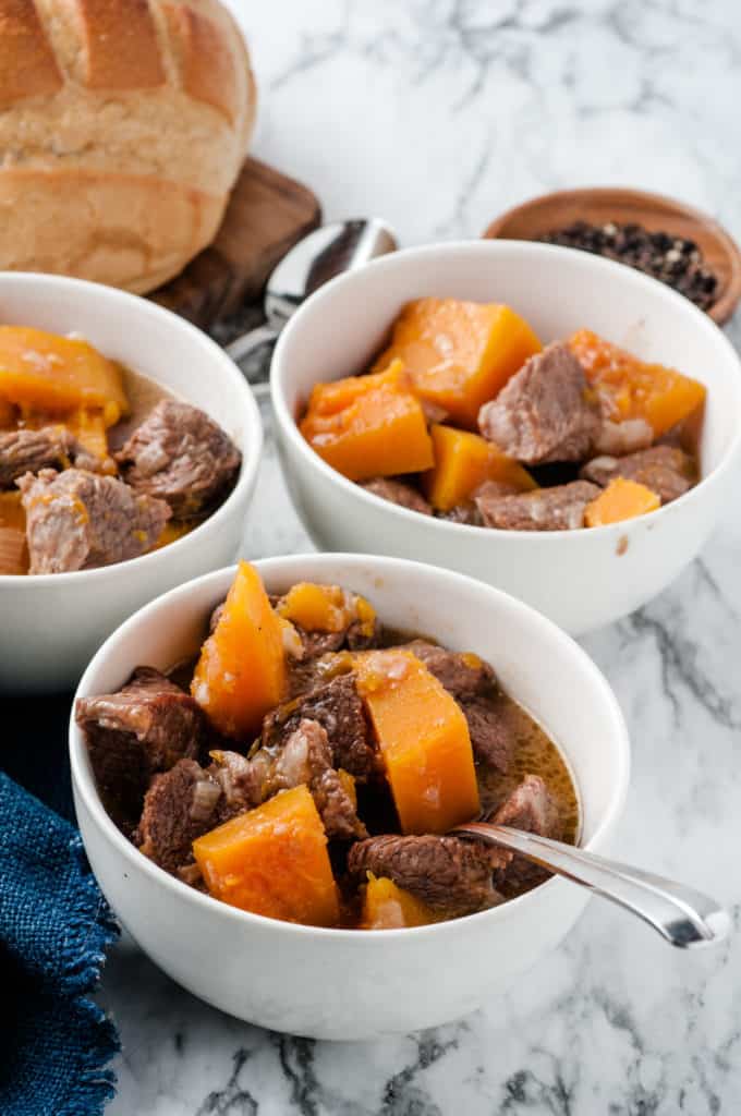 white bowls with butternut squash beef stew