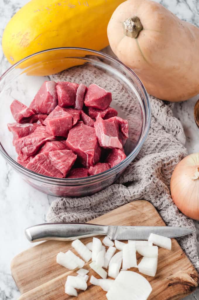 bowl of cubed raw beef and butternut squash