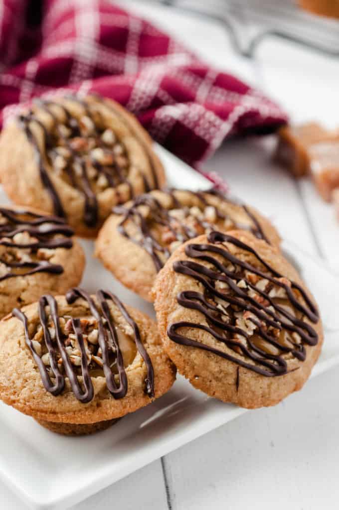 white plate with caramel cookie cups and red dish towel