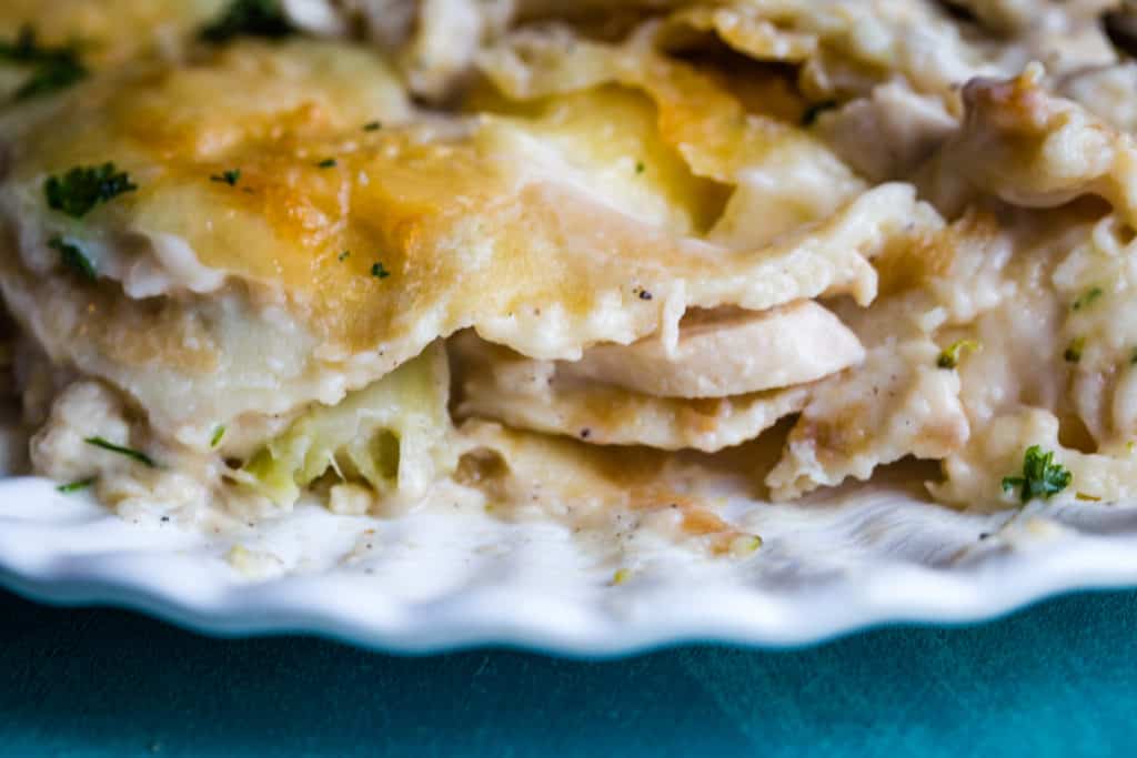 filling of broccoli chicken stuffed crepes on white plate