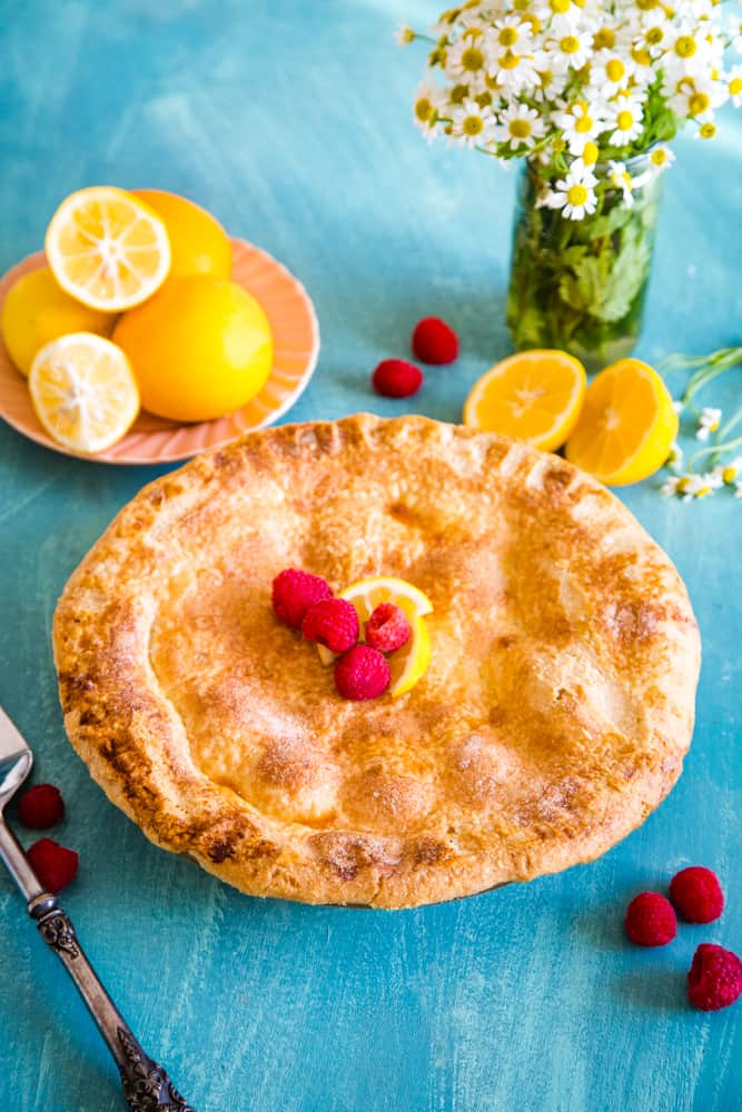 pie with lemons and flowers in background