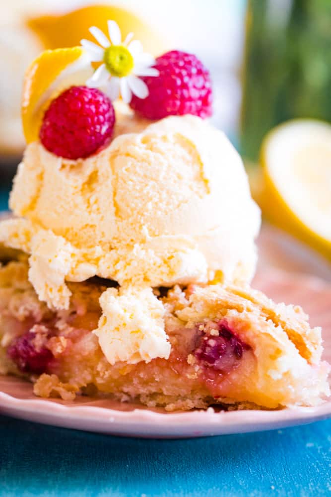 a slice of lemon raspberry pie with a scoop of ice cream