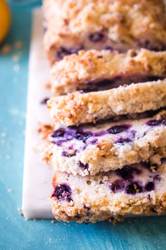 sliced lemon blueberry bread on white cutting board