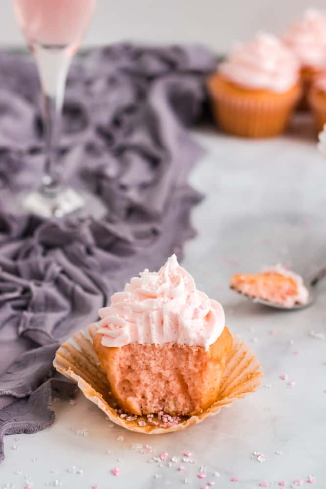 pink champagne cupcake with bite taken out