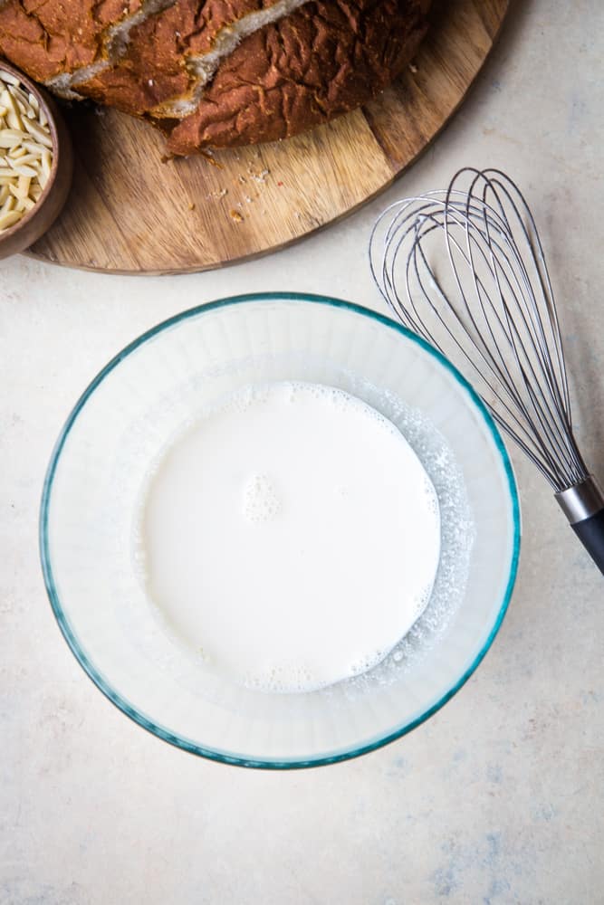 bowl of milk with whisk on the side