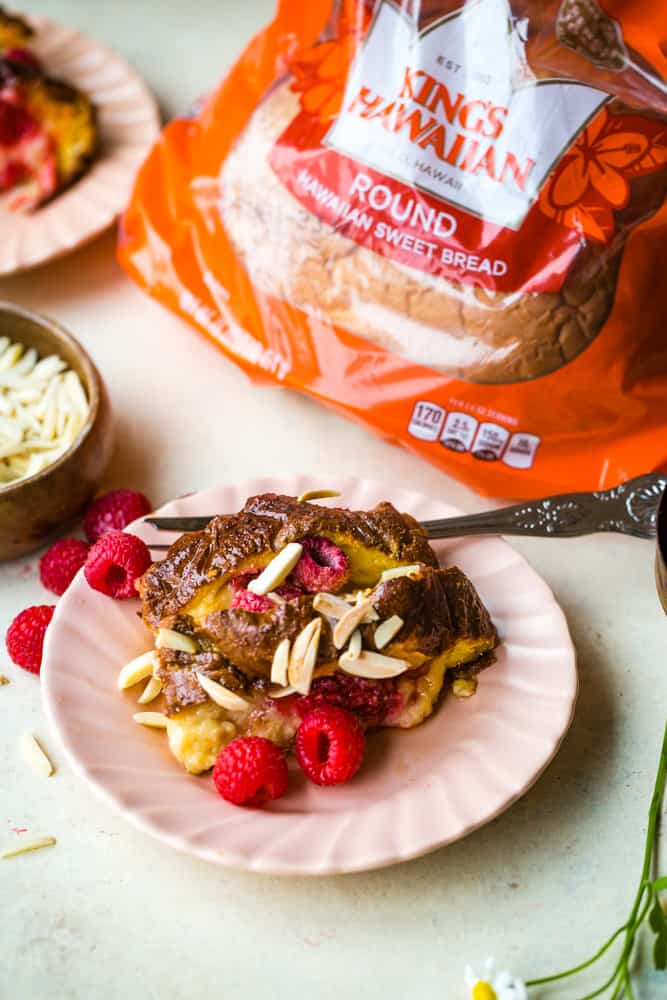 french toast on pink plate with kings hawaiian bread in background