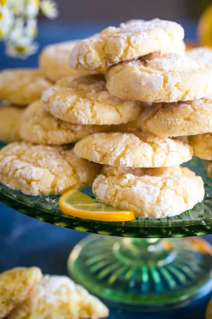 green cake plate with lemon bar cookies stacked