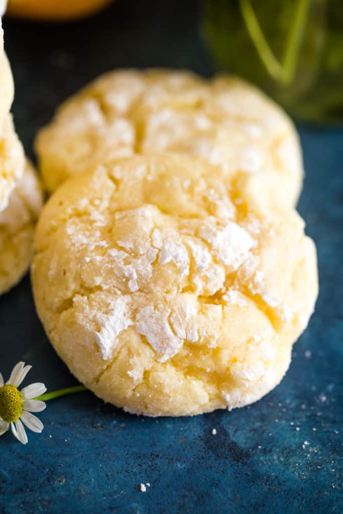 two lemon bar cookies on blue background