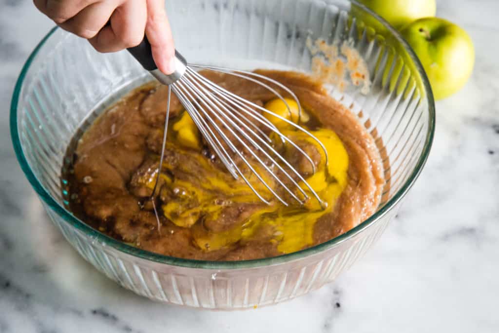 large glass bowl with applesauce bread batter