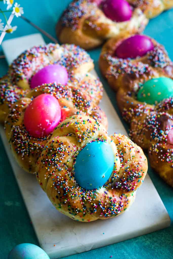 italian easter brioche bread baskets on white cutting board