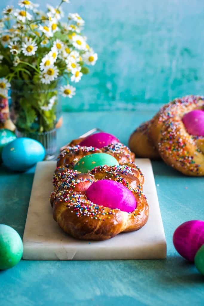 loaf of italian easter brioche bread on white cutting board