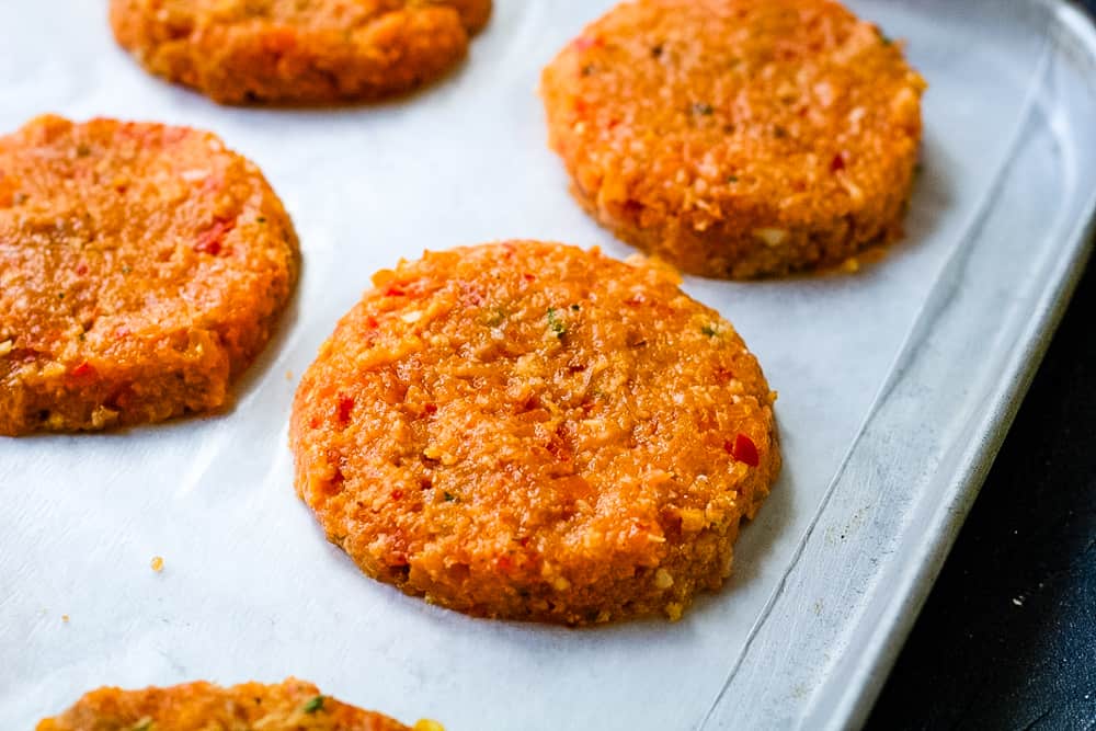 raw salmon patties on a cookie sheet