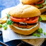 two salmon burgers in wood plank