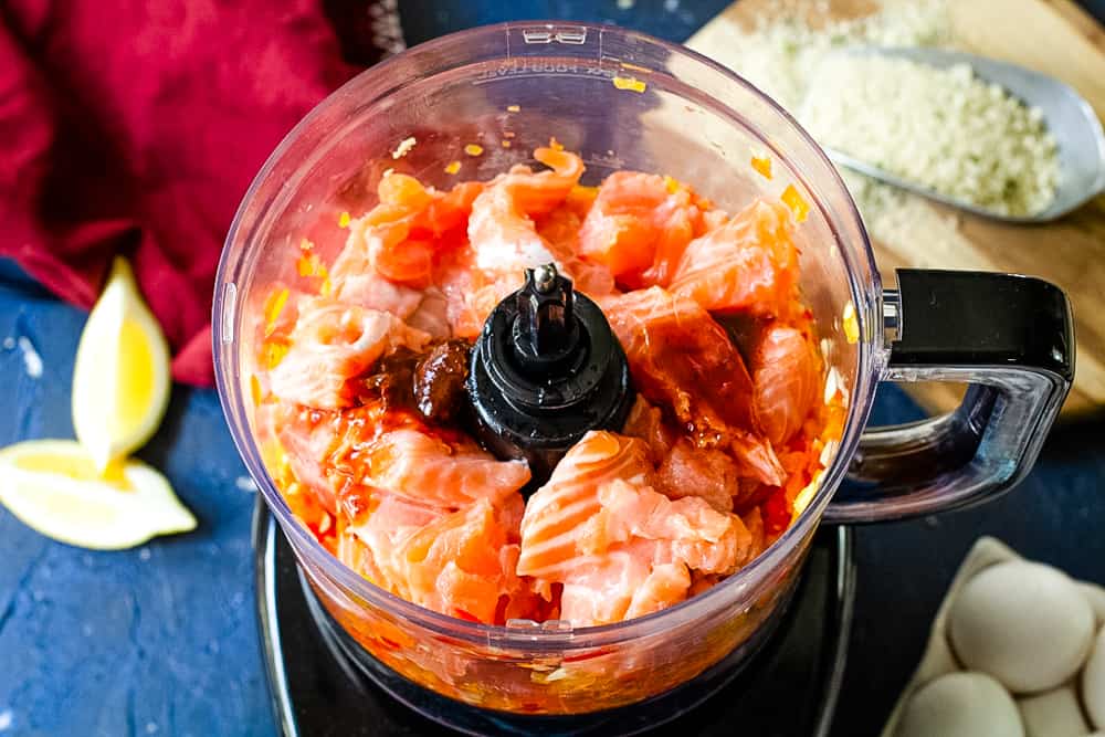 food processor with raw salmon and peppers inside