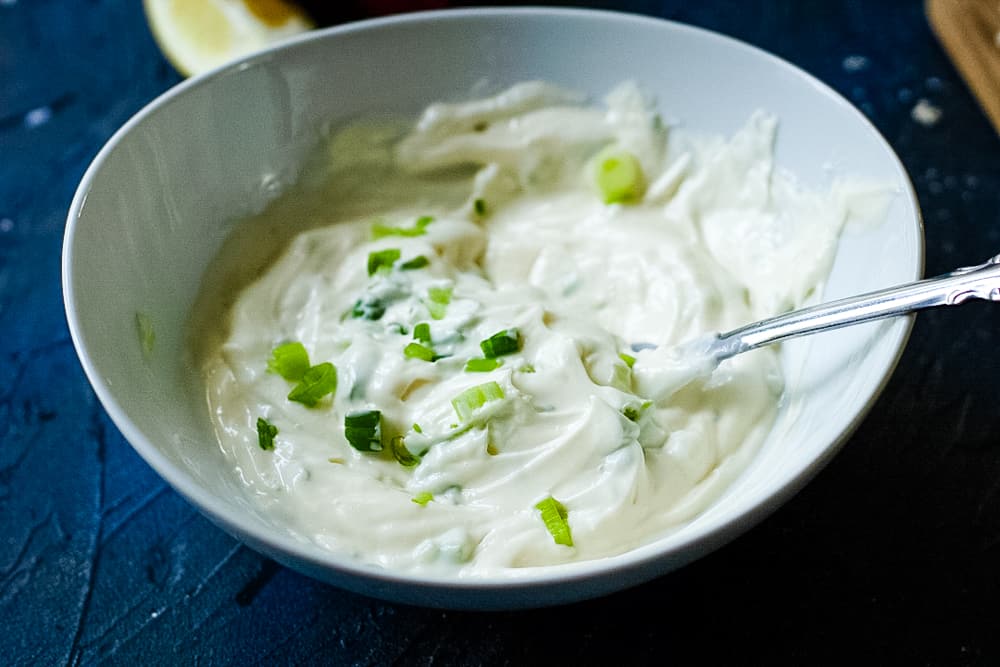 lemon chive may in a white bowl