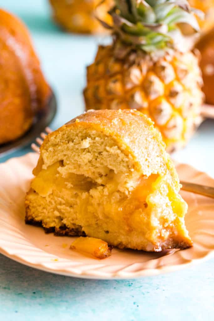 slice of pineapple bundt cake on coral plate