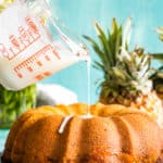 hand pouring glaze over bundt cake