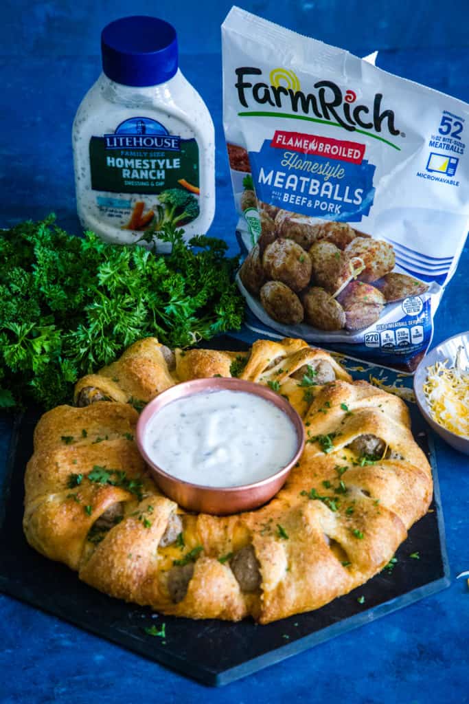 cheesy meatball ring with ranch and meatball bag in background