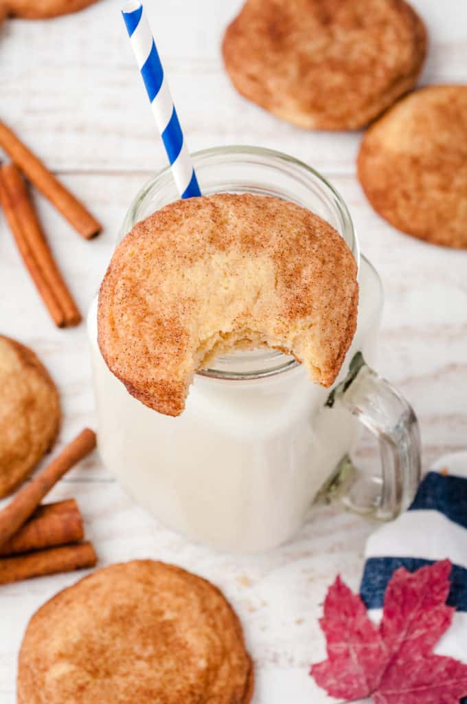 cup of milk with cookie on rim