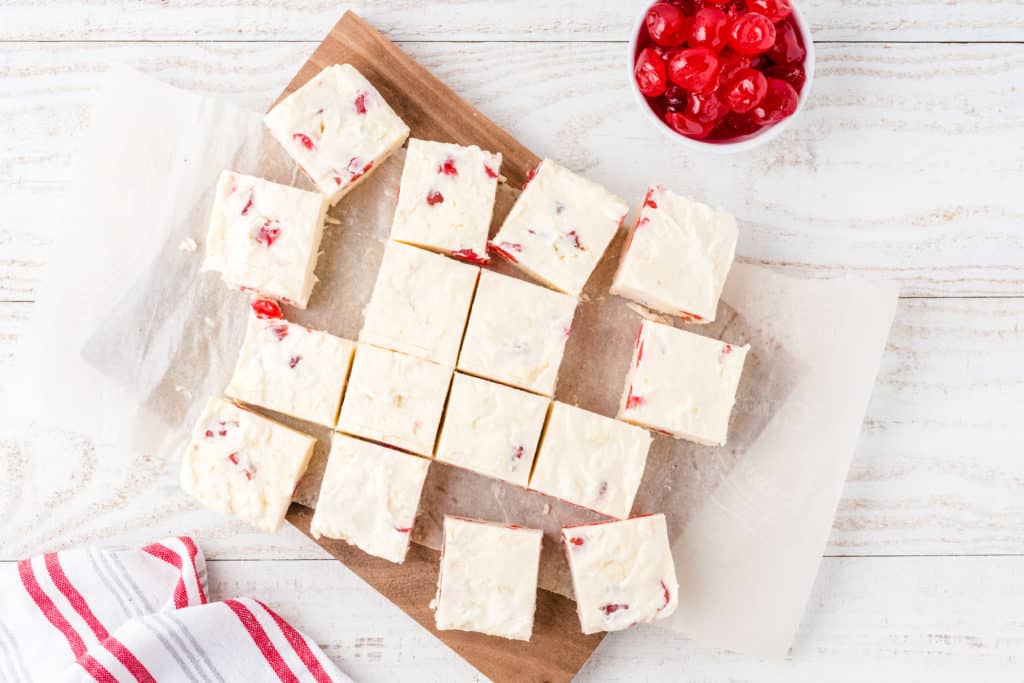 cherry cheesecake fudge cut into squares on a cutting board