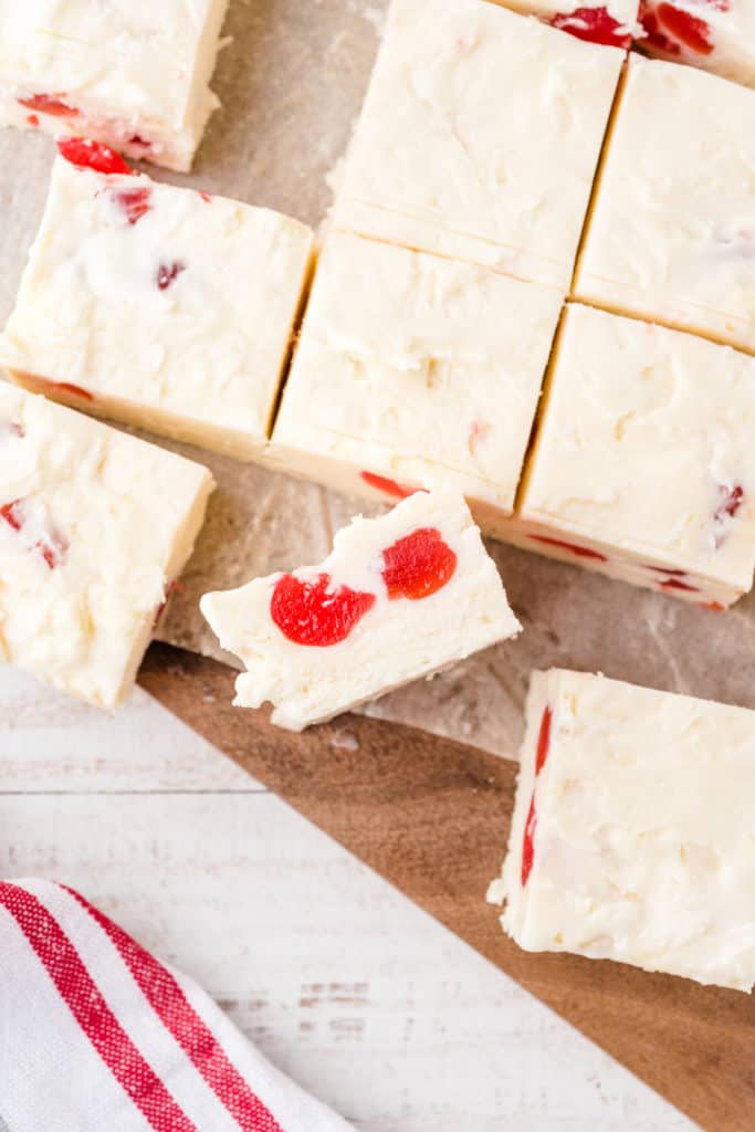 cherry cheesecake fudge squares on a cutting board