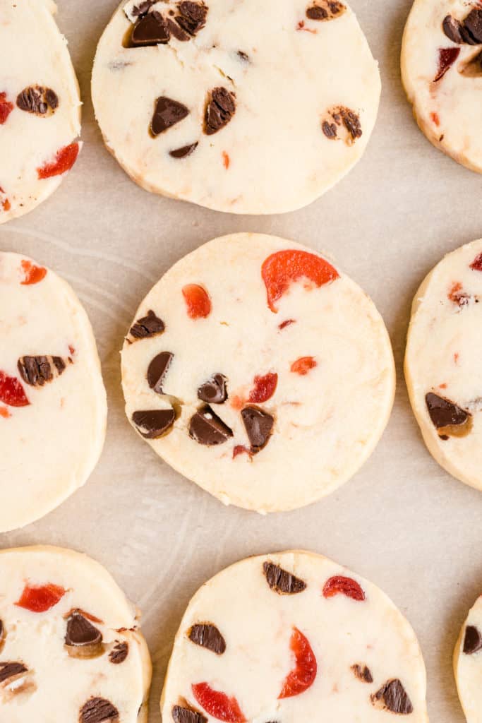 upclose shot of chocolate cherry shortbread cookies on parchment paper. 