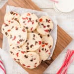 da plate of dark chocolate cherry cookies on wood cutting board