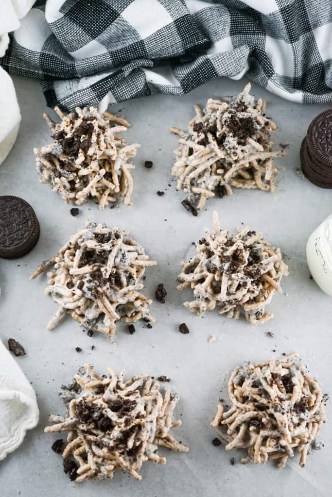 six cookies and cream haystacks on white background with plaid dish towel