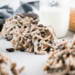 cookies and cream haystacks on white background with glass of milk