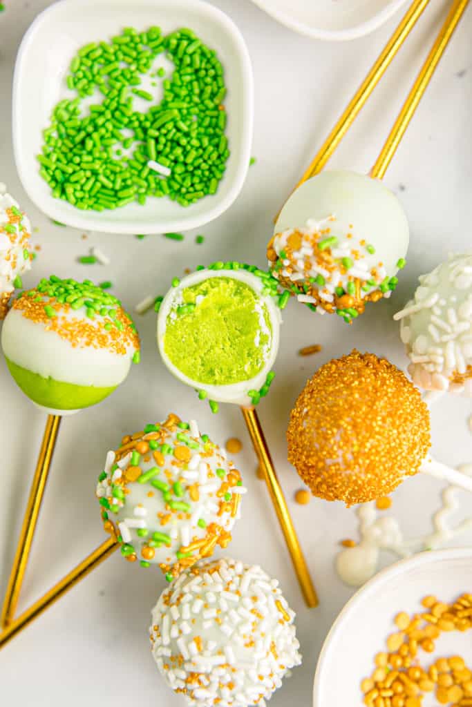 green cakes pops on a white background