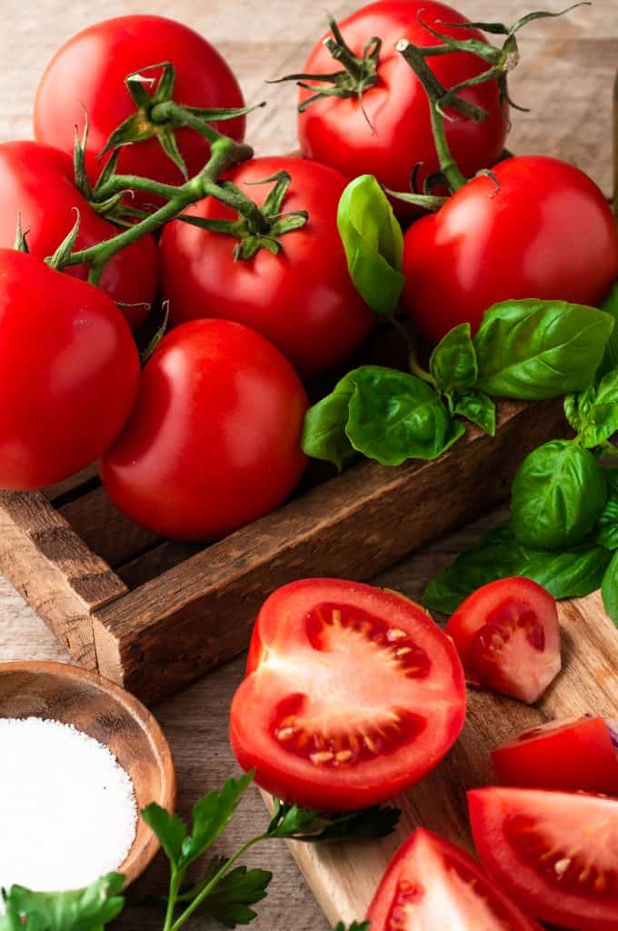 wood box filled with tomatoes on a vine