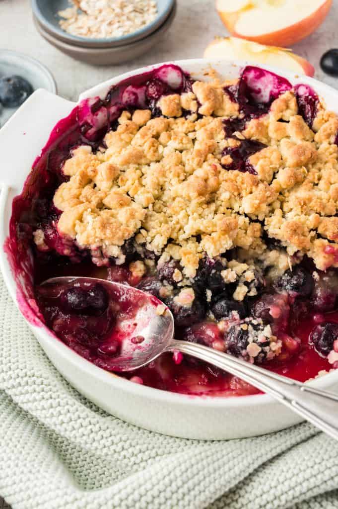 blueberry apple crumble in white serving dish