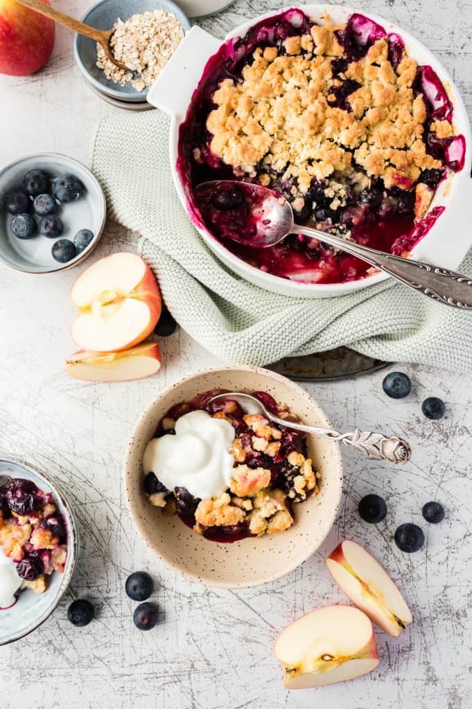 blueberry crumble in small bowl with ice cream