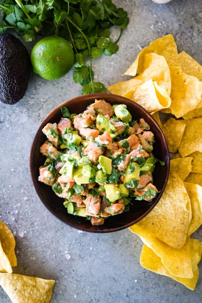 salmon ceviche in wood bowl with tortilla chips